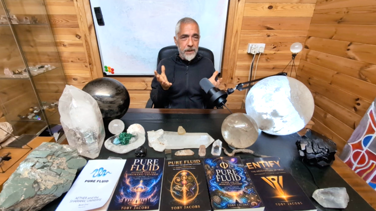 Toby Jacobs in his studio with crystals and his published books